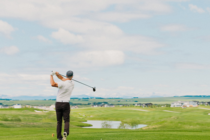 Man golfing at Harmony Calgary Golf course