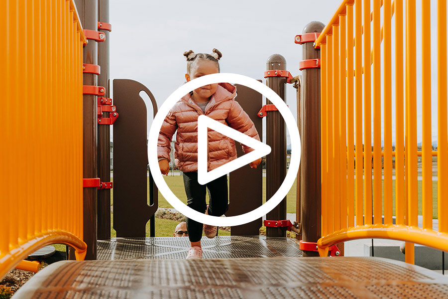 Girl playing on playground equipment in Harmony