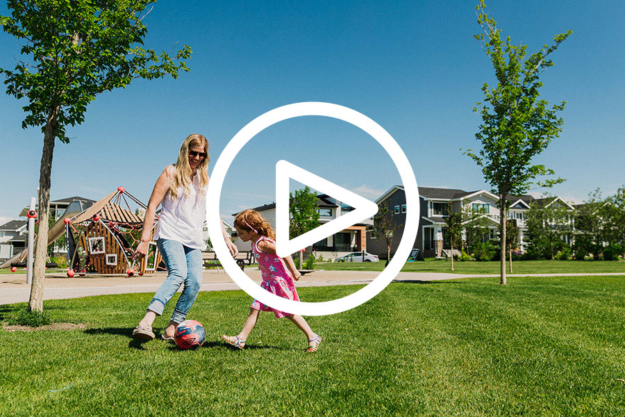 Mom and child playing soccer in the park